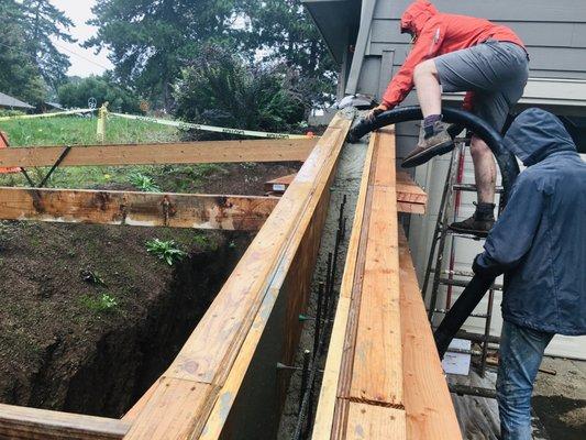 Concrete retaining wall pour in SE.