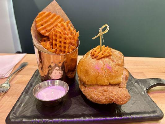 Spicy honey butter chicken sandwich with sweet potato fries and marshmallow sauce