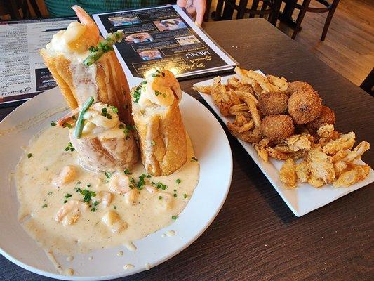 Bread tower with Pontchartrain sauce and gator balls on fried onions.