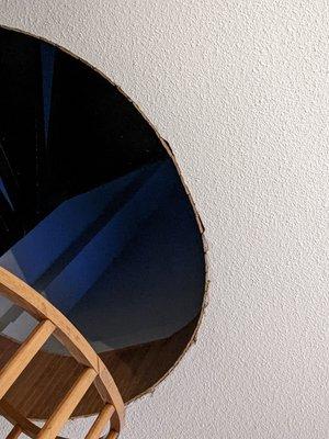 Staircase opening left unfinished with holes in plaster.