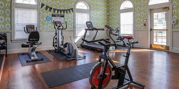 a gym with exercise equipment in a large room