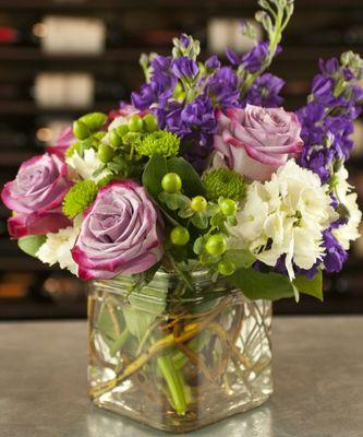 A fashionable design of garden fresh flowers in stylish purple, lavender and lime green hues.