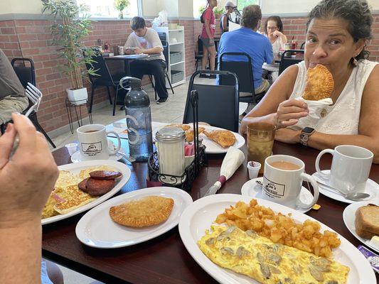 Mushroom omelette, empanadas, mangu platter, roasted potatoes.