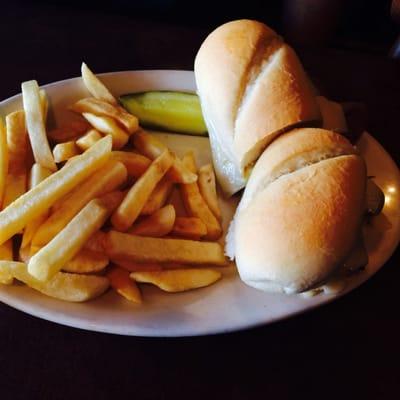 Delicious French Dip Sandwich with sautéed onions and topped with Swiss cheese and regular fries