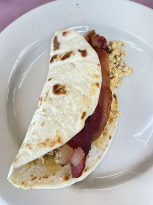 Breakfast tacos , chorizo , egg and added in a strip of bacon