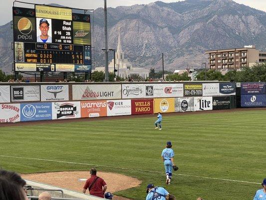 View of mountains, temple, apartments, and scoreboard