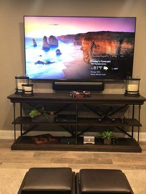 82" TV mounted on wall with Sonos sound.