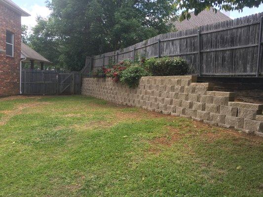 Paved stone retaining wall.