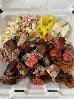 Steak, spicy sausage, pork shoulder, chicken wings, pasta and potato salad