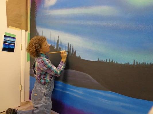 Painting happy little trees for a mural in a massage therapy room.