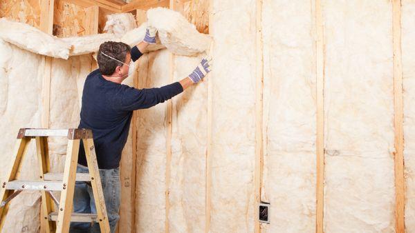 Fiberglass batt insulation installed in exterior walls.