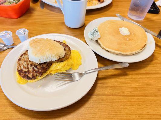 Egg sausage cheese biscuit with side of pancakes