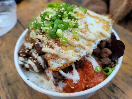 Korean bulgogi beef bowl with avocado and fried egg