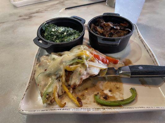 Cajun chicken smothered cheese and peppers- sides of mushrooms and creamed spinach.