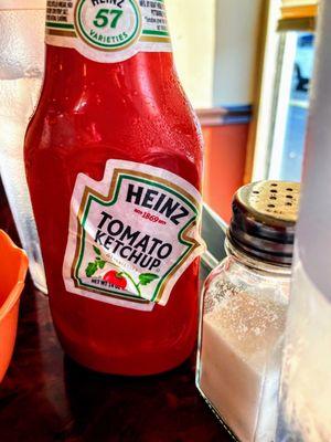 Over-recycled bottle of Not-Heinz Ketchup, complete with slippery label.