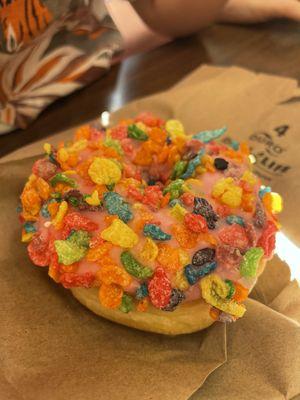 Strawberry frosted donut with fruity pebbles on too