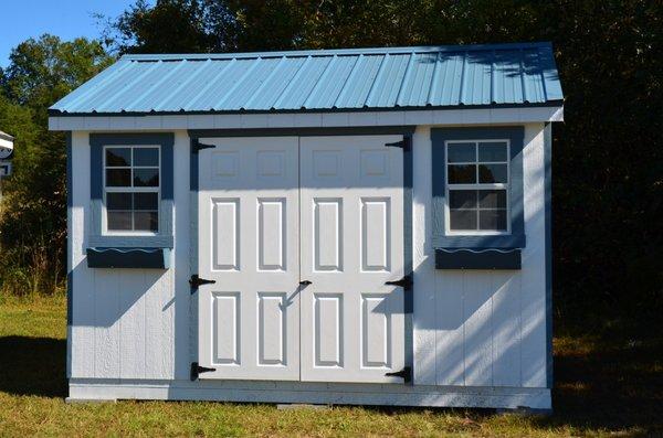 12X10 Painted wood cottage with a metal roof (available as an option in 25 color choices), and flower boxes