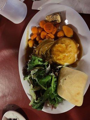 The dinner (Non vegetarian) salad, mash potatoes, roast beef, roll, carrots, butter