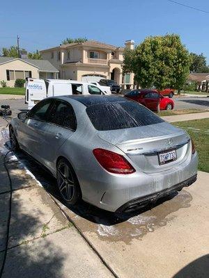 Mercedes Benz getting a Express+ Car Wash on a Sunny Day.