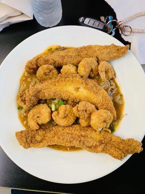 Fried catfish shrimp and crawfish etouffee  over dirty rice