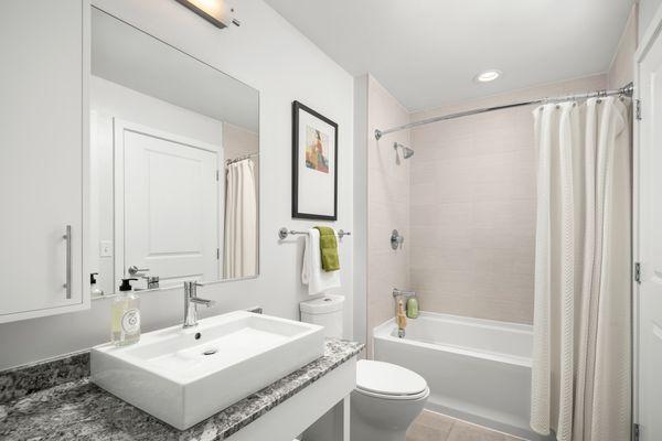 Pampering potential ahead. Luxurious bathrooms featuring Porcelanosa tile and custom white wood millwork will be your favorite spot to unwin