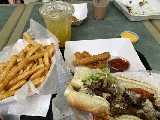 Passion fruit lemonade, philly steak, double order fries, and mozzarella sticks.