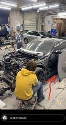 Car In Shop With Body Panels Laid Against Car