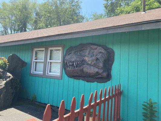 dino skull head on the side of the building