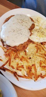 Chicken Fried Steak with cream Gravy,  Hashbrowns, and over medium eggs .