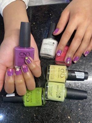 Purple nail color with flowers design.