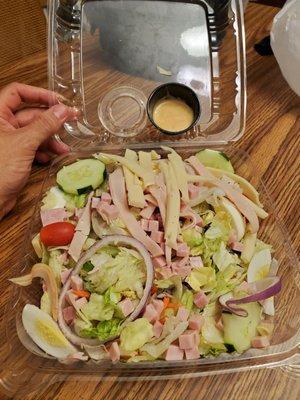 Tiny cup of dressing for entire salad.