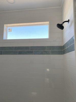 Subway with blue accent tile installed in master bathroom.