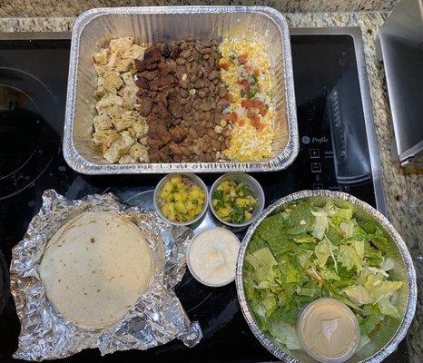 Street tacos. Pork al pastor, citrus chicken, elote, borracho beans, and green salad