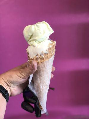 Key lime and sweet cream ice cream in a fresh made waffle cone