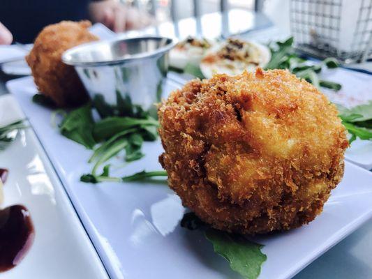 Great Balls O' Fire: panko crusted and deep fried Mac n' Cheese balls stuffed with Louisiana sausage.