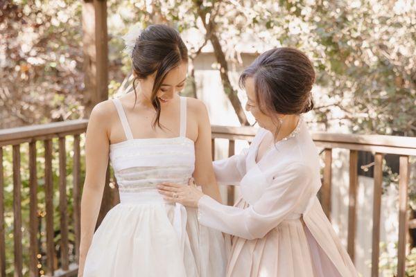 Bride in a modern hanbok dress. And mother in traditional hanbok.