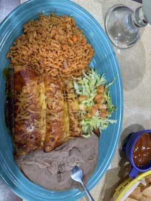 Kathy's plate 1) Taco, guacamole, (1) Tamale, (2) Cheese Enchiladas served with rice and beans