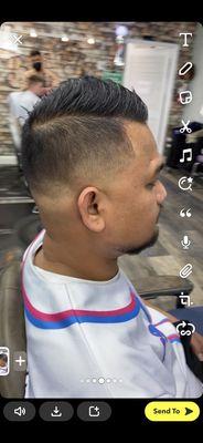 Mid skin fade and side comb.