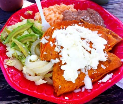 Enchiladas potosinas with pickled piggie skins (that's the white strips that look like onions).