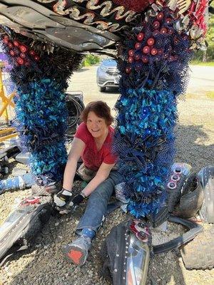 This is Angela Haseltine Pozzi the artist working on the feet. She had help from volunteers and staff to make all the parts she used.