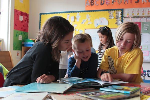 Fifth grade students pair up with pre-K students.