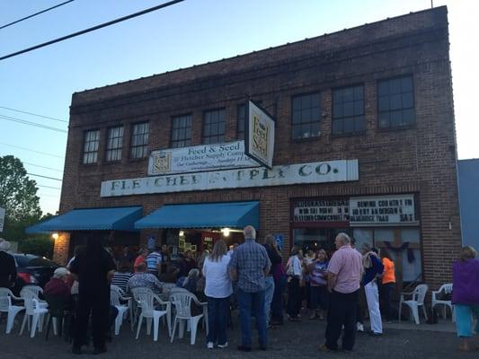 Popular bluegrass concert equals extra seating out front. Everyone was super friendly and accommodating.