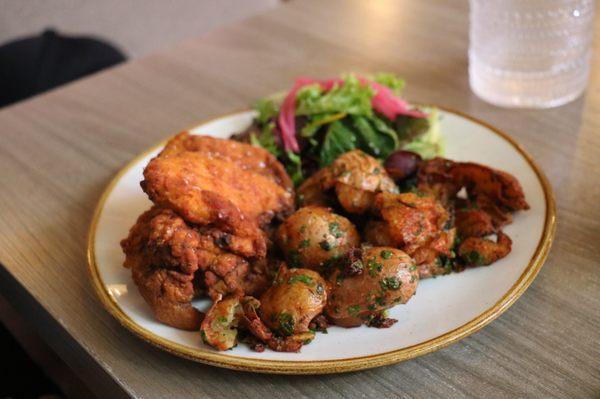 Fried chicken and potatoes with salad