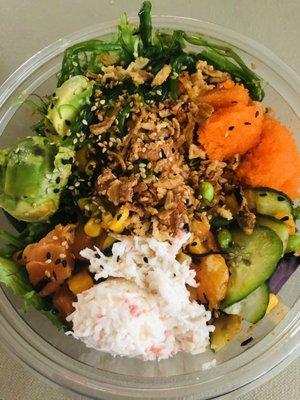 Build your own Poke bowl with salmon on a bed of greens and a lot of different toppings.