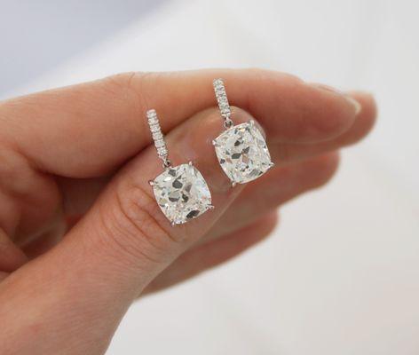 Cushion cut diamond drop earrings.