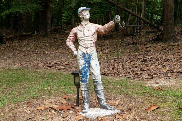 20TH CENTURY IRON AND STONE LAWN JOCKEY