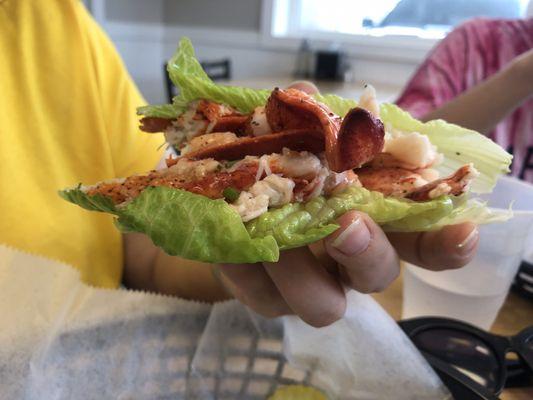 Lobster roll on lettuce.