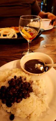 Fried pork pieces  with black beans and white rice.