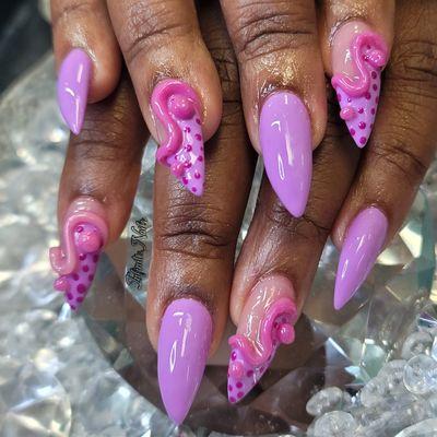 Acrylic pointy nails with purple gel polish and 3d art design