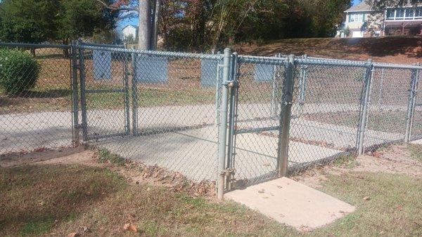 Double gated concrete entry at both ends of the dog park